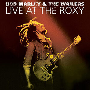 Cover album art of Bob Marley and the Wailers Live at the Roxy with a guitar and his head thrown back in bliss.